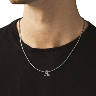 a person wearing a nipura 925 sterling silver Initial-A pendant on a silver chain necklace. 
